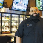 Ravi Takhar coordinates a daunting selection of craft beers at IBU Taproom & Bottle Shop. Photo by Michael Cabana.