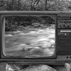 Hollow TV screen with a river behind it